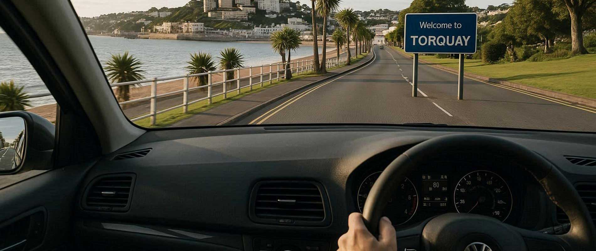 A red compact car stopped at lights in torquay